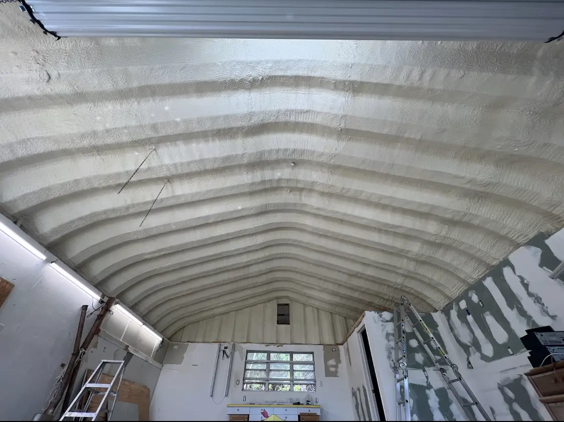 Spray polyurethane foam applied to the underside of a metal roof deck in Kenmore